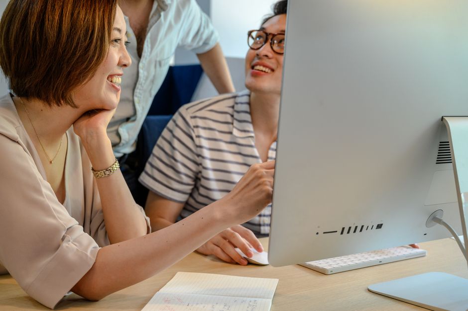 Technical team reviewing website performance findings on a monitor